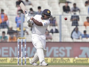 Sri Lanka's Rangana Herath plays a shot during the fourth day of their first test cricket match against India in Kolkata, India, Sunday, Nov. 19, 2017. (AP Photo/Bikas Das)
