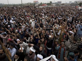 Protesters shout anti-government slogans during a sit-in protest at an entrance of Islamabad, Pakistan, Friday, Nov. 24, 2017. Religious groups continues their rally at the edge of Islamabad, disrupting daily life in capital, demand the removal of the country's law minister over a recently omitted reference to the Prophet Muhammad in a constitutional bill. (AP Photo/B.K. Bangash)
