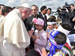 In this image provided by L'Osservatore Romano, Pope Francis arrives in Yangon, Myanmar, on Monday, Nov. 27, 2017.  The pontiff is in Myanmar for the first stage of a week-long visit that will also take him to neighboring Bangladesh. (L'Osservatore Romano via AP)