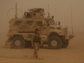 In this Monday, Nov. 6, 2017 photo, U.S. Marines prepare to build a military site during a sandstorm in western Anbar, Iraq. The US-led coalition's newest outpost in the fight against the Islamic State group is in this dusty corner of western Iraq near the border with Syria where several hundred American Marines operate close to the battlefront, a key factor in the recent series of swift victories against the extremists. (AP Photo/Khalid Mohammed)
