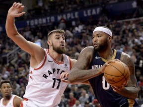 Raptors centre Jonas Valanciunas looks to block New Orleans Pelicans centre DeMarcus Cousins during second half NBA action in Toronto on Thursday night.