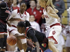 Louisville's Jazmine Jones controls a loose ball against Indiana's Tyra Buss, right, during the first half of an NCAA college basketball game Thursday, Nov. 30, 2017, in Bloomington, Ind. (AP Photo/Darron Cummings)