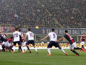 Bologna's Simone Verdi, right, scores the opening goal during a Serie A soccer match between Bologna and Crotone at the  Dall'Ara stadium in Bologna, Italy, Saturday, Nov. 4, 2017. (Giorgio Benvenuti/ANSA via AP)