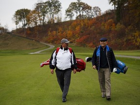 Brian Tenaschuk, left, and Tim Haunn walk the fairway of the Credit Valley Golf and Country Club.