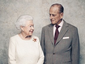 In this handout photo issued by Camera Press and taken in Nov. 2017, Britain's Queen Elizabeth and Prince Philip pose for a photograph in the White Drawing Room pictured against a platinum-textured backdrop at Windsor Castle, England.