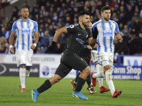 Manchester City's Sergio Aguero celebrates after scoring during the English Premier League soccer match between Huddersfield Town and Manchester City at John Smith's stadium, in Huddersfield, England, Sunday, Nov. 26, 2017. (AP Photo/Rui Vieira)