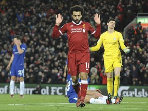 Liverpool's Mohamed Salah celebrates after scoring during the English Premier League soccer match between Liverpool and Chelsea at Anfield, Liverpool, England, Saturday, Nov. 25, 2017. (AP Photo/Rui Vieira)