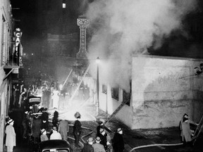 FILE - In this Nov. 28, 1942 file photo, smoke pours from the Cocoanut Grove nightclub, right, during a fire in the Back Bay section of Boston, where 492 people died and hundreds more were injured. The fire still stands today as the nation's deadliest nightclub fire and led to stricter enforcement of fire codes and to innovations in the treatment of burn victims. (AP Photo, File)