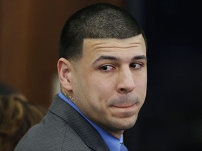 FILE - In this Friday, April 14, 2017 file photo, Former New England Patriots tight end Aaron Hernandez turns to look in the direction of the jury as he reacts to his double murder acquittal in the 2012 deaths of Daniel de Abreu and Safiro Furtado, at Suffolk Superior Court in Boston.  Dr. Ann McKee of the CTE Center at Boston University presented the findings of her examination of Hernandez's brain on Thursday, Nov. 9. McKee says she could not say that Hernandez's behavior was a result of his severe case of chronic traumatic encephalopathy. But she says Hernandez suffered substantial damage to several important parts of the brain, including the frontal lobe. Hernandez  killed himself in April, while serving life in prison for murder. (AP Photo/Stephan Savoia, Pool, File)