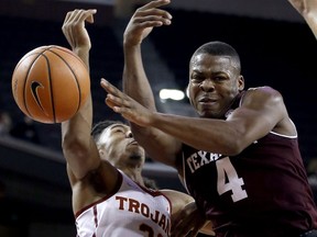 Texas A&M guard JJ Caldwell (4) loses the ball with Southern California guard Elijah Stewart (30) defending during the first half of an NCAA college basketball game in Los Angeles, Sunday, Nov. 26, 2017. (AP Photo/Alex Gallardo)