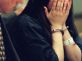 FILE  - In this May 8, 1998 file photo, Deputy Public Defender Roger Alexander puts his arm around Jeen "Gina" Han in Orange County Superior Court in Santa Ana, Calif., after she was sentenced to 26 years to life for plotting the murder of her twin sister Sunny. Han has been granted parole after nearly two decades in prison. (Ygnacio Nanetti/Orange Country Register via AP, Pool, File)