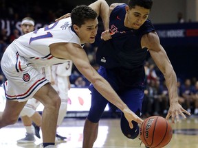 Saint Mary's Evan Fitzner, left, and Cal State Fullerton's Jackson Rowe chase a loose ball during the first half of an NCAA college basketball game Wednesday, Nov. 15, 2017, in Moraga, Calif. (AP Photo/Ben Margot)
