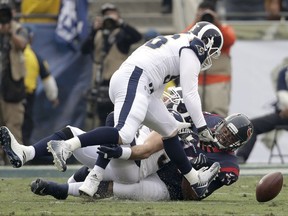 Los Angeles Rams linebacker Matt Longacre, top, recovers a fumble against the Houston Texans during the first half of an NFL football game Sunday, Nov. 12, 2017, in Los Angeles. (AP Photo/Jae C. Hong)