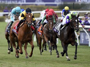 Javier Castellano, right, rides Rushing Fall to victory in the Juvenile Fillies Turf horse race during the first day of the Breeders' Cup, Friday, Nov. 3, 2017, in Del Mar, Calif. (AP Photo/Denis Poroy)