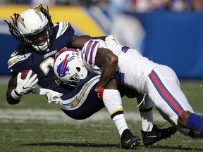 Los Angeles Chargers running back Melvin Gordon, left, is tackled by Buffalo Bills defensive back Leonard Johnson during the first half of an NFL football game Sunday, Nov. 19, 2017, in Carson, Calif. (AP Photo/Jae C. Hong)