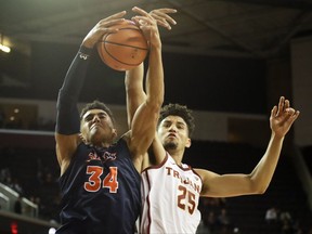 Cal State Fullerton forward Jackson Rowe, left, battles for a rebound with Southern California forward Bennie Boatwright during the first half of an NCAA college basketball game in Los Angeles, Friday, Nov. 10, 2017. (AP Photo/Chris Carlson)