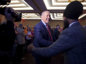 Premier John Horgan shakes hands with Federal NDP Leader Jagmeet Singh speaks to delegates and supporters during the B.C. NDP Convention at the Victoria Conference Centre in Victoria, B.C., on Saturday, November 4, 2017. THE CANADIAN PRESS/Chad Hipolito