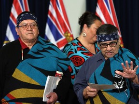 Coast Salish representative and First Nations health council member Paul Sam, (left), looks on as Coast Salish elder Greg Sam talks about a report released about recommendations from a Death Review Panel on First Nations Youth and youth adults during a press conference in the Hall of Honour at Legislature in Victoria, B.C., on Wednesday, November 15, 2017. THE CANADIAN PRESS/Chad Hipolito