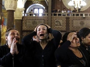 FILE - In this April 10, 2017 file photo, women cry during the funeral for those killed in a Palm Sunday church attack in Alexandria Egypt, at the Mar Amina church. Egypt has been battling an insurgency in the Sinai led by an affiliate of the Islamic State group that intensified after the military's 2013 ouster of the Muslim Brotherhood from power. Hundreds have been killed in what has become a grinding stalemate in Sinai. The militants have expanded their attacks to other parts of Egypt, carrying out deadly bombings of churches to terrorize the Christian minority and deadly gunbattles with security forces. (AP Photo/Samer Abdallah, File)