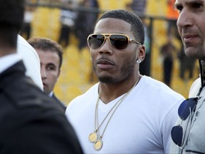 FILE- In this March 13, 2015 file photo, rapper Nelly approaches the stage for a concert in Irbil, northern Iraq. Nelly is to perform at a male-only concert on Dec. 14 2017, in Saudi Arabia, but his planned concert in the ultraconservative country is not being welcomed by everyone. Some Saudis on social media are pointing to the American rapper's 2015 guilty plea for possession of marijuana, while others say it's disgraceful in light of a rape accusation against the rapper. (AP Photo/Seivan M. Salim, File)