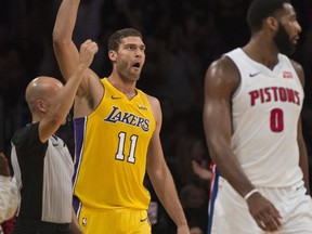 Los Angeles Lakers center Brook Lopez celebrates his three-pointer as Detroit Pistons center Andre Drummond looks away during the first half of an NBA basketball Tuesday, Oct. 31, 2017, in Los Angeles. (AP Photo/Kyusung Gong)
