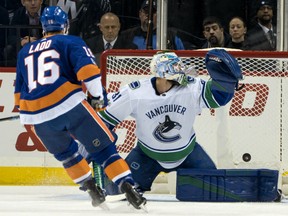 Andrew Ladd of the Islanders fires a goal past Vancouver Canucks' netminder Andres Nilsson during the first period of their game Tuesday night in New York.