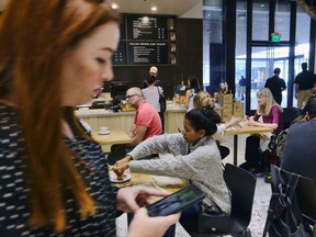 In this Wednesday, Nov. 22, 2017, photo, customers sit and have their morning coffee and pastries at the LaVazza Cafe, at Eataly, at the Westfield Century City Mall in the Century City section of Los Angeles. On Tuesday, Nov. 28, 2017, the  Conference Board releases its November index on U.S. consumer confidence. (AP Photo/Richard Vogel)