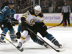 Boston Bruins left wing Jake DeBrusk (74) move the puck around a San Jose Sharks defender to score a goal during the first period of an NHL hockey game Saturday, Nov. 18, 2017, in San Jose, Calif. (AP Photo/Tony Avelar)