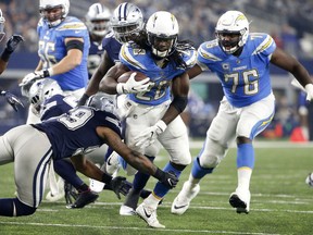 Dallas Cowboys linebacker Anthony Hitchens (59) attempts to stop Los Angeles Chargers running back Melvin Gordon (28) in the second half of an NFL football game, Thursday, Nov. 23, 2017, in Arlington, Texas. (AP Photo/Michael Ainsworth)