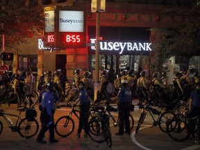 FILE - In this Sept. 17, 2017 file photo, police gather as demonstrators march in response to a not guilty verdict in the trial of former St. Louis police officer Jason Stockley in St. Louis. St. Louis voters will decide Tuesday, Nov. 7, 2017 on a half-cent sales tax increase that would fund pay raises for police,.(AP Photo/Jeff Roberson, File)