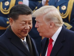 In this Nov. 9 file photo, U.S. President Donald Trump, right, chats with Chinese President Xi Jinping during a welcome ceremony at the Great Hall of the People in Beijing.