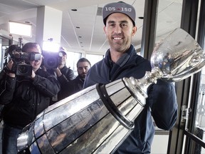 Toronto Argonauts quarterback Ricky Ray holds the Grey Cup as speaks to members of the media as the teams returns to Toronto on Monday, November 27 2017. After a celebration that lasted into the wee hours, a tired group of Toronto Argonauts arrived home Monday morning with the Grey Cup in tow. THE CANADIAN PRESS/Chris Young