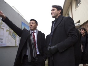 Prime Minister Justin Trudeau (right) stands with Jason Chen, Development Director at Toronto Community Housing as he visits a housing development in Toronto's Lawrence Heights neighbourhood ahead of a policy announcement, on Wednesday November 22, 2017. THE CANADIAN PRESS/Chris Young