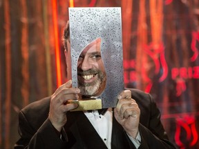 Author Michael Redhill celebrates winning the 2017 Giller Prize for his novel "Bellevue Square" in Toronto on Monday, November 20, 2017. THE CANADIAN PRESS/Chris Young