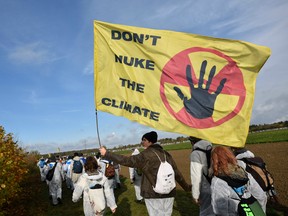 Environmentalist march close to the Hambach lignite open pit mine near Elsdorf, western Germany, on November 5, 2017, as they protest against fossil-based energies like coal, having negative impact on the climate change. The nearby western city of Bonn will host the UN Climate Change Conference (COP23) from November 6 to 19, 2017, where "nations of the world will meet to advance the aims and ambitions of the Paris Agreement.