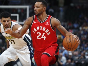 Toronto Raptors forward Norman Powell, front, drives past Denver Nuggets guard Jamal Murray in the first half of an NBA basketball game Wednesday, Nov. 1, 2017, in Denver. (AP Photo/David Zalubowski)