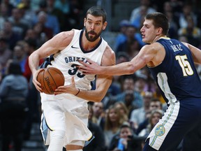 Memphis Grizzlies center Marc Gasol, left, of Spain, pulls in a loose ball as Denver Nuggets center Nikola Jokic, of Serbia, defends in the first half of an NBA basketball game Friday, Nov. 24, 2017, in Denver. (AP Photo/David Zalubowski)