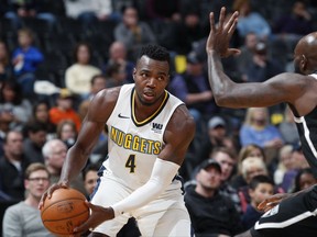 Denver Nuggets forward Paul Millsap, left, drives to the basket as Brooklyn Nets forward Quincy Acy defends in the first half of an NBA basketball game Tuesday, Nov. 7, 2017, in Denver. (AP Photo/David Zalubowski)