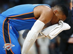 Oklahoma City Thunder guard Russell Westbrook holds a towel to his head during a timeout after he was hit in the face by Denver Nuggets center Nikola Jokic, of Serbia, during the first half of an NBA basketball game Thursday, Nov. 9, 2017. (AP Photo/David Zalubowski)