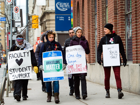 Teachers and faculty staff picket outside George Brown College in Toronto on Thursday.