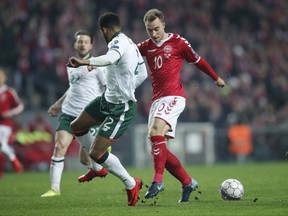 Ireland's Cyrus Christie and Denmark's Christian Eriksen , right, vie for the ball during the World Cup qualifying play-off first leg soccer match between Denmark and the Republic of Ireland at Parken stadium in Copenhagen, Denmark, Saturday, Nov. 11, 2017. (Jens Dresling/Ritzau via AP)