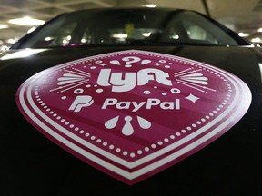 A vehicle with the logo from the Lyft ride sharing service is shown at Seattle-Tacoma International Airport, Thursday, March 31, 2016 in Seattle. THE CANADIAN PRESS/AP-Ted S. Warren