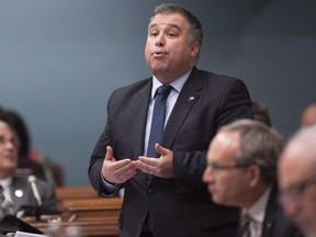 Quebec Education and Family Minister Sebastien Proulx responds to the opposition during question period at the National Assembly, in Quebec City on Wednesday, May 31, 2017. Proulx said he was "extremely saddenened" by the story of a 15 year old boy who took his own life after persistent bullying at school. THE CANADIAN PRESS/Jacques Boissinot