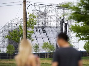 The chief coroner of Ontario will be holding an inquest into the death of a drum technician for the British rock band Radiohead who died in 2012 after a stage collapse in Toronto. People look at a collapsed stage at Downsview Park in Toronto on Saturday, June 16, 2012. THE CANADIAN PRESS/Nathan Denette