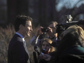 A lawyer for members of the military and other federal agencies who were investigated, sanctioned and fired because of their sexual orientation says a "fair and reasonable settlement" has been reached with the government. Prime Minister Justin Trudeau takes questions from the media outside the Confederation Centre of the Arts in Charlottetown, P.E.I., on Thursday, Nov 23, 2017. THE CANADIAN PRESS/Nathan Rochford
