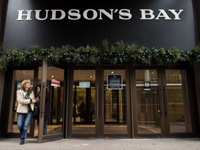 A women leaves the Hudson Bay Company store in Toronto on Wednesday, November 1, 2017. Hudson's Bay Co. (TSX:HBC) says it has cost it more than US$425,000 so far to comply with demands for documents from Canada's competition watchdog as it investigates alleged deceptive pricing practices. THE CANADIAN PRESS/Nathan Denette