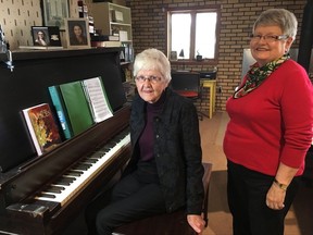 Bobby McLean, left, and Lois Miller pose with a piano in ths undated handout image provided by Global News. A musical relic that survived one of Halifax's darkest days is going up for sale. Lois Miller says her grandfather bought a Stohlman New York piano from Phinney's Music Shop on Barrington Street, installing it in the family home decades ago. THE CANADIAN PRESS/HO-Global News- Jennifer Grudic