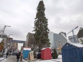 A 26-metre-high balsam fir Christmas tree is seen in Tuesday, December 6, 2016 in downtown Montreal. Montreal's infamous ugly Christmas tree of 2016 â€" one that generated headlines and social media posts around the world because of its awkward appearance â€" is the inspiration behind an entire village this holiday season. THE CANADIAN PRESS/Ryan Remiorz