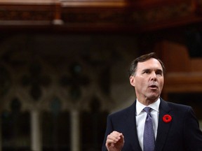 Minister of Finance Bill Morneau stands during question period in the House of Commons on Parliament Hill in Ottawa on Thursday, Nov. 2, 2017. Parliament's spending watchdog says Liberal changes to passive investments rules for small businesses could rake in up to $6 billion annually in new tax revenues after the next decade. THE CANADIAN PRESS/Sean Kilpatrick