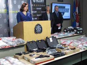 Alberta Justice Minister Kathleen Ganley, left to right, Insp. Patty McCallum and Supt. Chad Coles speak to media after announcing a record seizure of fentanyl and meth in Calgary Wednesday November 22, 2017. THE CANADIAN PRESS/Bill Graveland
